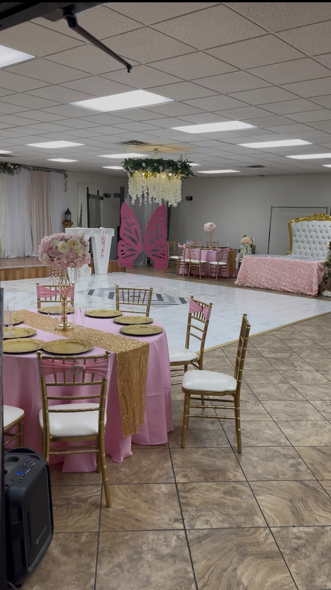 Salon Avalon event venue with gold chairs, floral centerpieces, and a dance floor